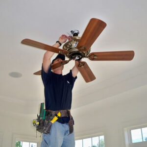Residential electrician installs ceiling fan